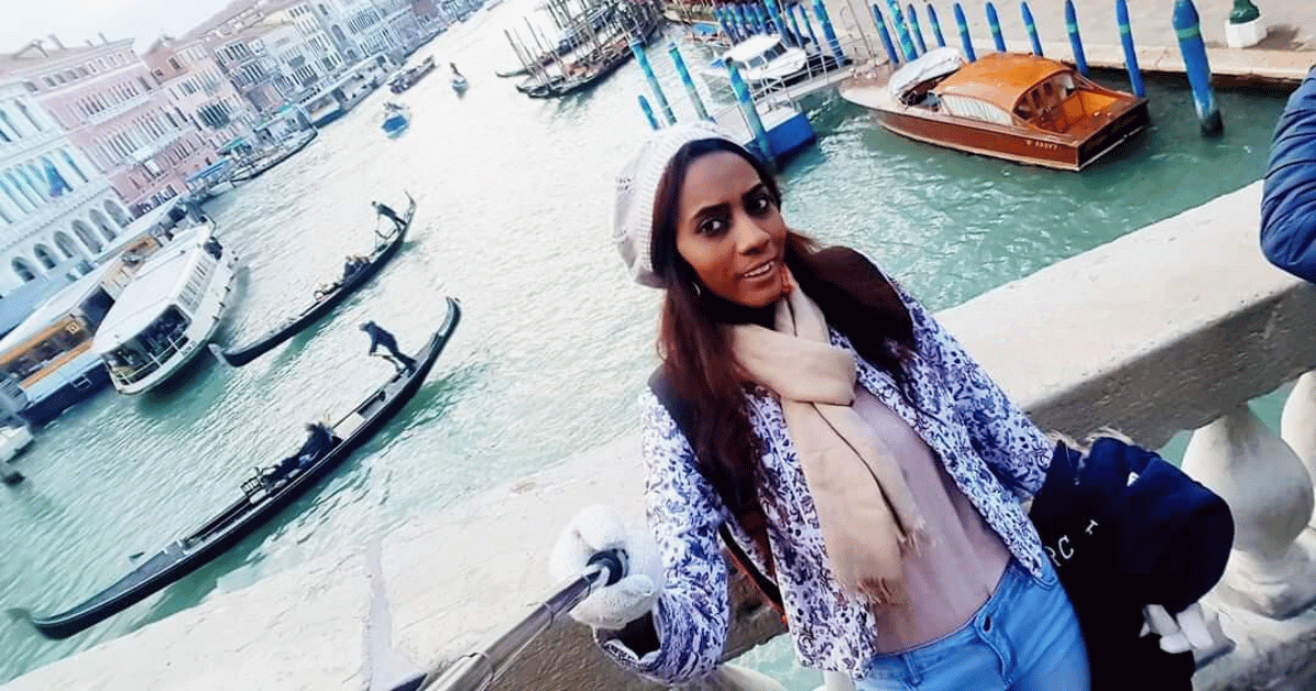 Safaa, a solo female traveler from Sudan, embraces the beauty of Venice's canals